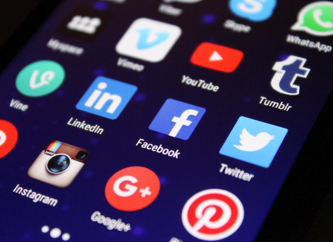 our-experience Close-up of a smartphone screen showing various social media app icons such as Facebook and Twitter.