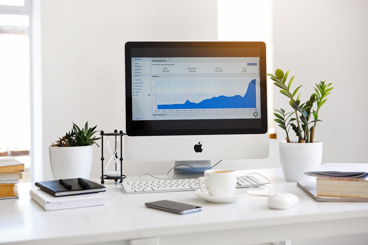 about-02 A clean, contemporary workspace featuring a desktop with analytics on the screen and plants for a fresh look.